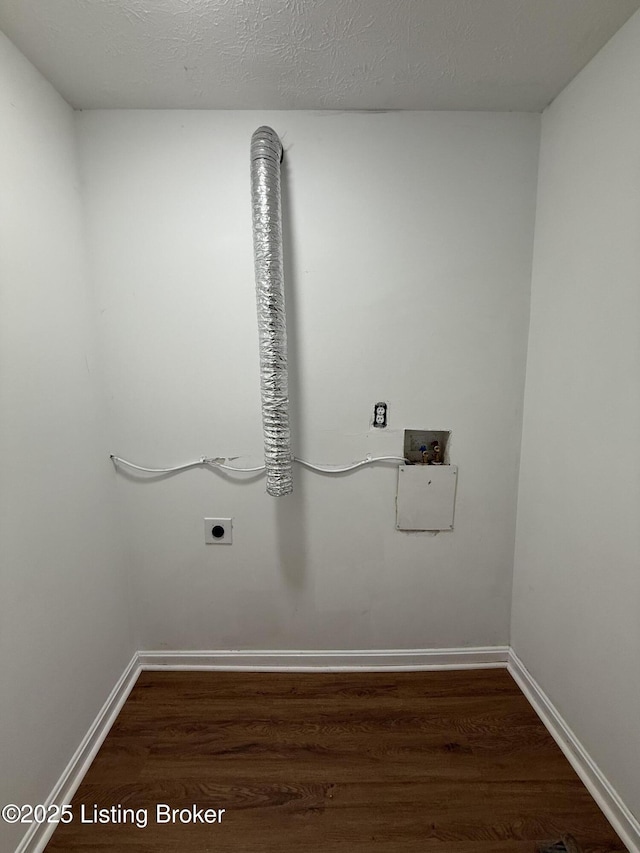 washroom with electric dryer hookup, washer hookup, dark hardwood / wood-style floors, and a textured ceiling