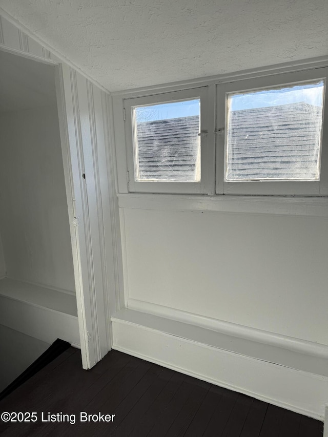 interior details featuring hardwood / wood-style flooring and a textured ceiling