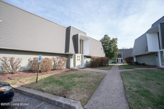 view of home's exterior featuring a lawn