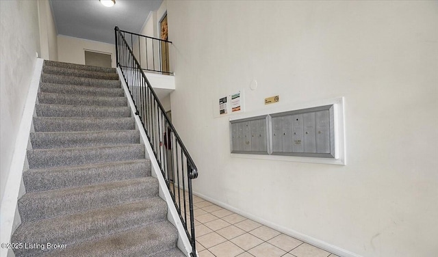 staircase featuring tile patterned floors and mail boxes