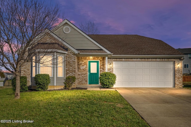 view of front of house featuring a lawn and a garage