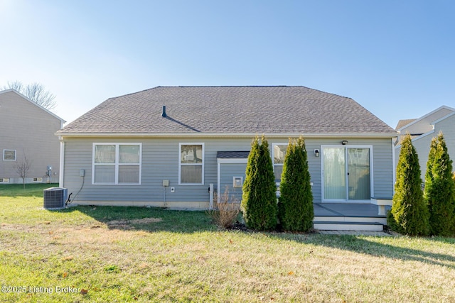 back of property with a yard and central air condition unit