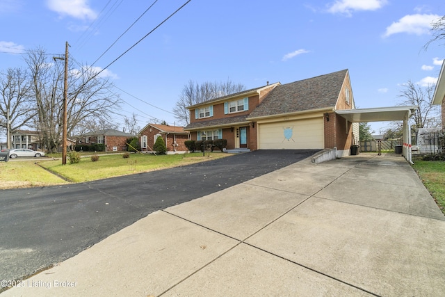 view of front facade featuring a front yard, a garage, and a carport