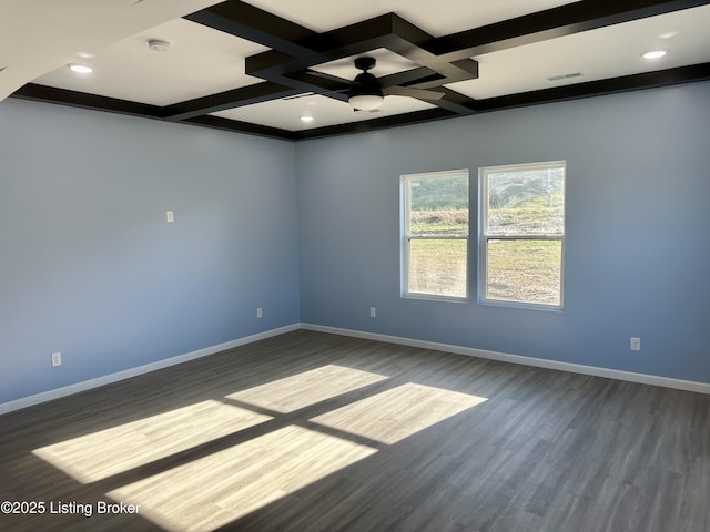 empty room featuring beamed ceiling, ceiling fan, dark wood-type flooring, and coffered ceiling