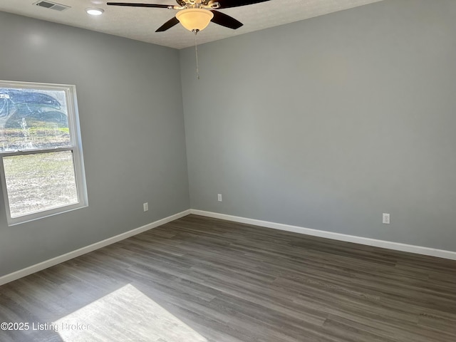 empty room featuring ceiling fan and dark hardwood / wood-style flooring