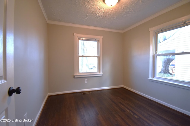 unfurnished room with dark hardwood / wood-style flooring, a textured ceiling, and ornamental molding