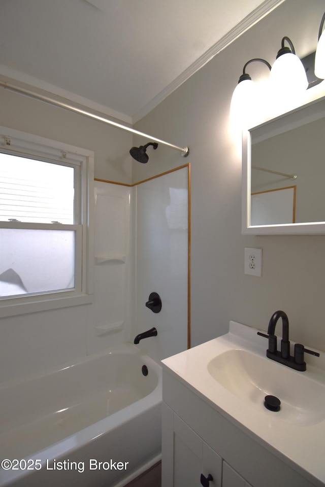 bathroom with vanity, crown molding, and bathtub / shower combination