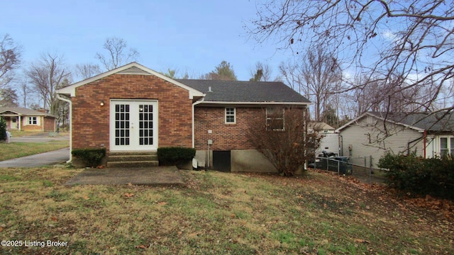 back of property featuring a lawn