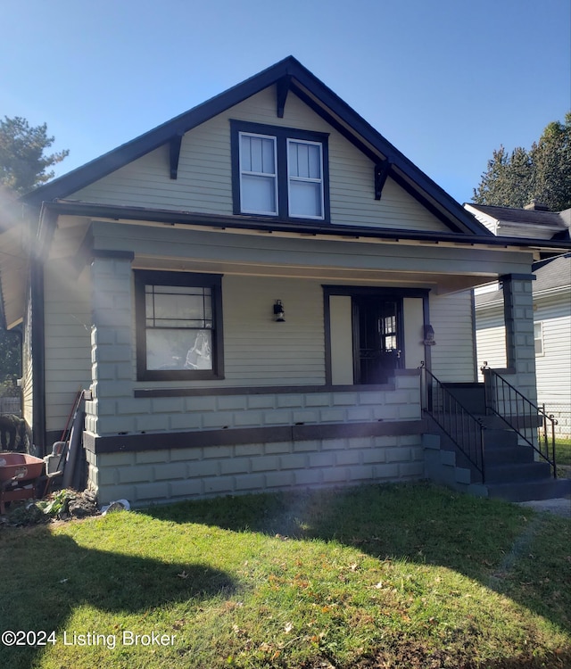 bungalow-style home with a porch and a front yard