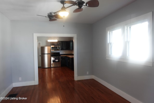 interior space featuring ceiling fan and dark wood-type flooring