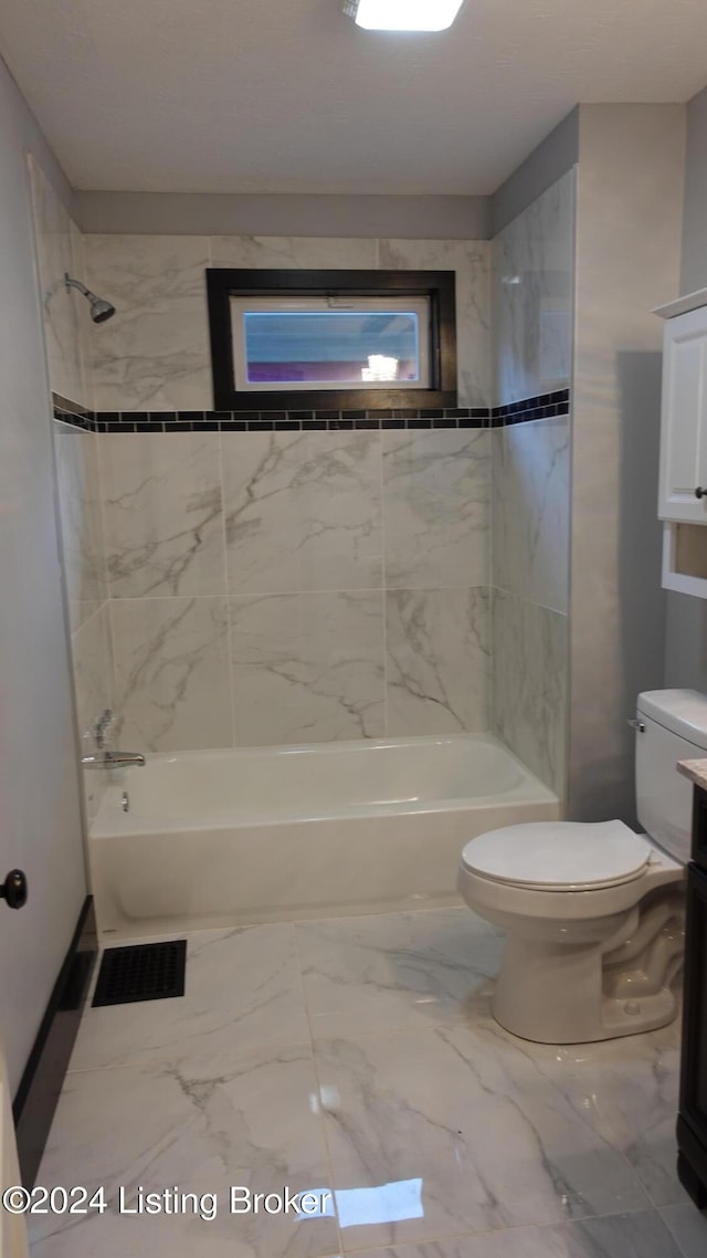 full bathroom with vanity, toilet, and tiled shower / bath