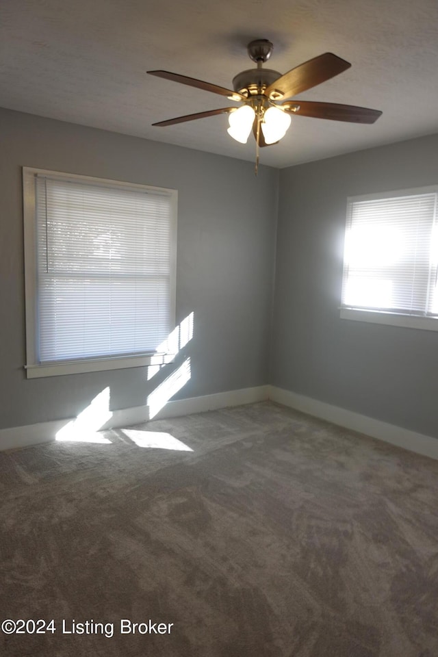 spare room featuring carpet flooring and ceiling fan