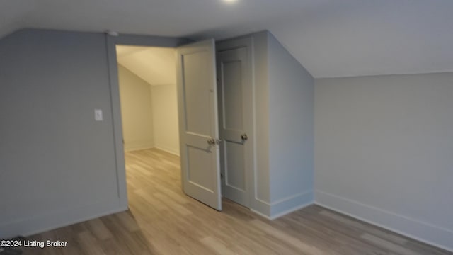 bonus room with light hardwood / wood-style floors and lofted ceiling