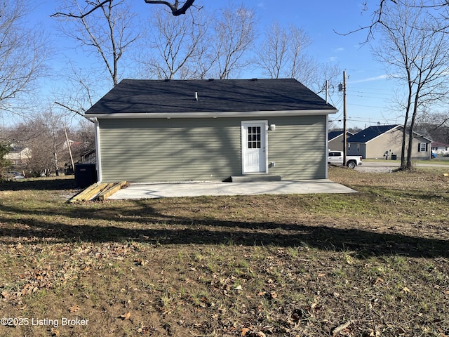 rear view of property featuring a yard