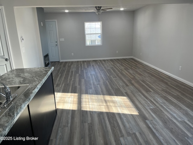 interior space featuring ceiling fan, dark hardwood / wood-style flooring, and sink