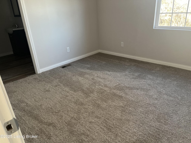 empty room with dark carpet