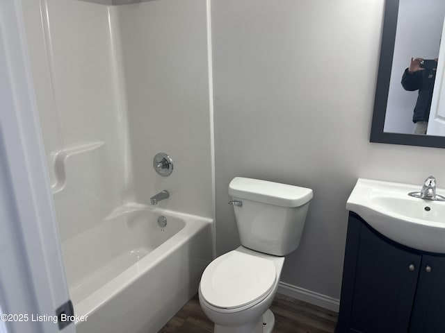 full bathroom with hardwood / wood-style flooring, vanity,  shower combination, and toilet