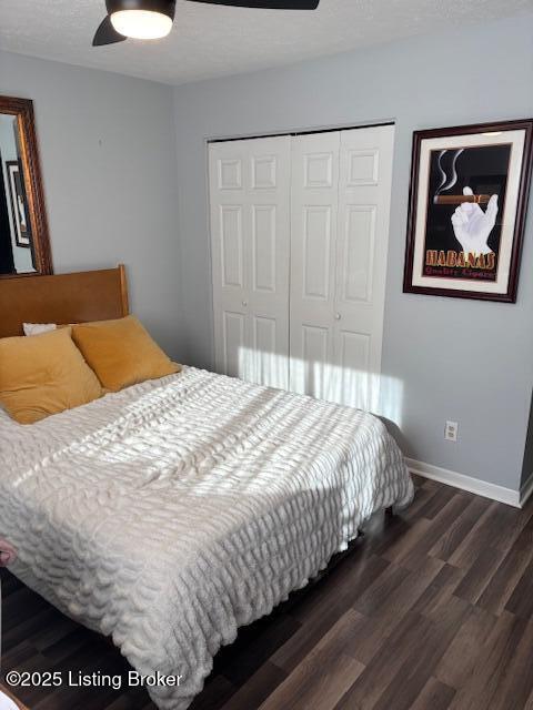 bedroom featuring dark hardwood / wood-style flooring, a closet, and ceiling fan