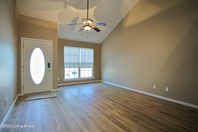 foyer entrance featuring high vaulted ceiling, ceiling fan, and wood-type flooring