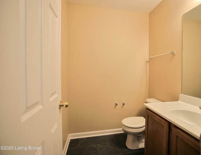 bathroom featuring toilet and vanity