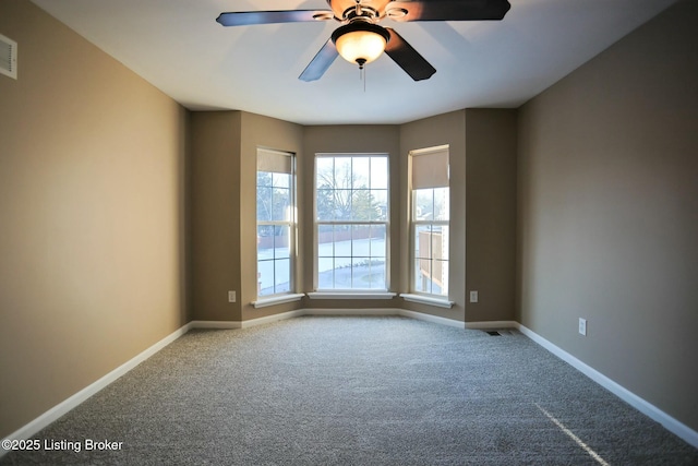 carpeted empty room featuring ceiling fan