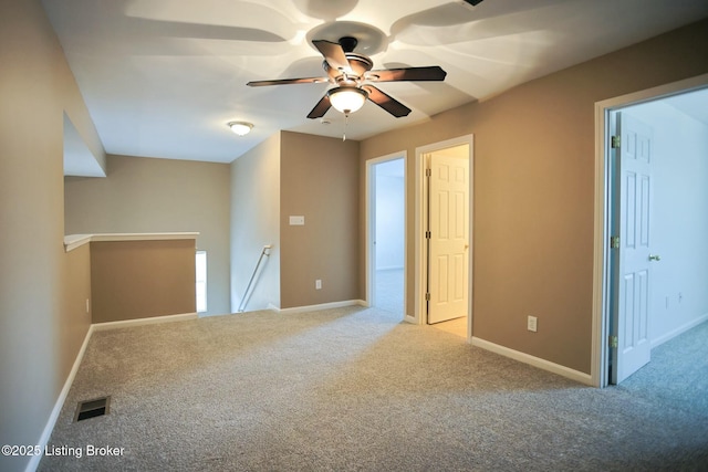 unfurnished room featuring ceiling fan and light colored carpet