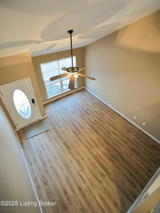 unfurnished living room featuring wood-type flooring and ceiling fan