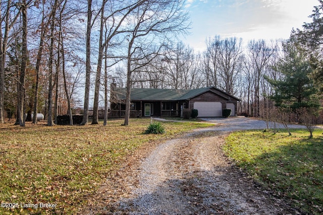 ranch-style home featuring a garage and a front lawn