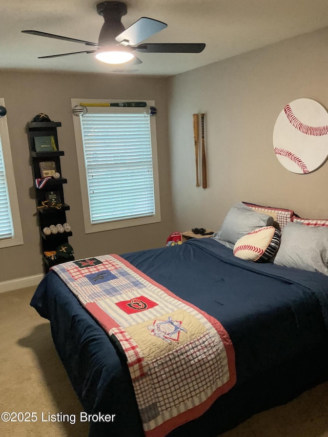 bedroom with ceiling fan, multiple windows, and carpet flooring