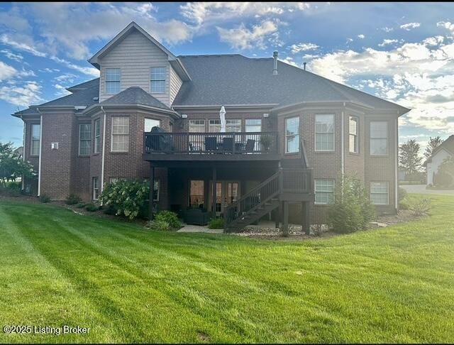 rear view of house with a deck and a lawn