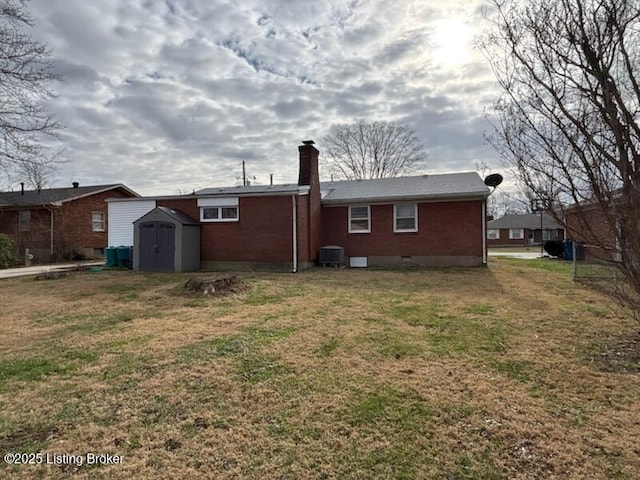 back of house with a shed, a lawn, and central air condition unit