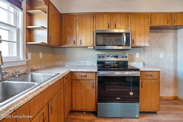 kitchen with hardwood / wood-style floors and appliances with stainless steel finishes