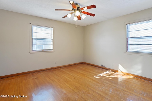 unfurnished room with ceiling fan, light hardwood / wood-style flooring, and a wealth of natural light