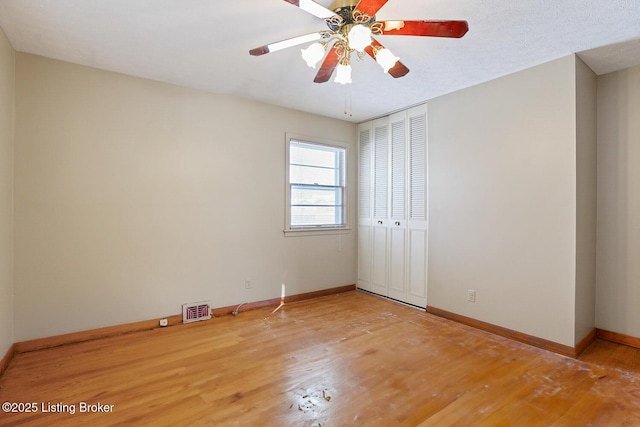 spare room featuring ceiling fan and hardwood / wood-style floors