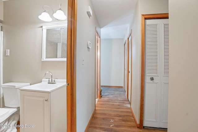 hallway with sink and dark hardwood / wood-style floors