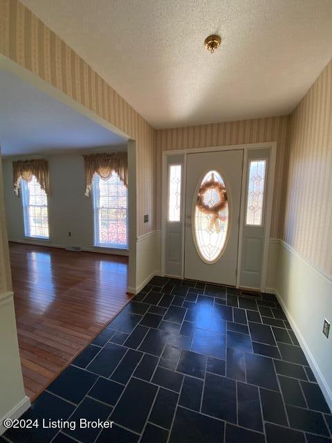 entryway featuring a textured ceiling