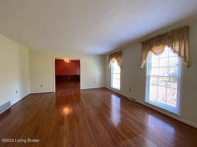 unfurnished room featuring dark wood-type flooring