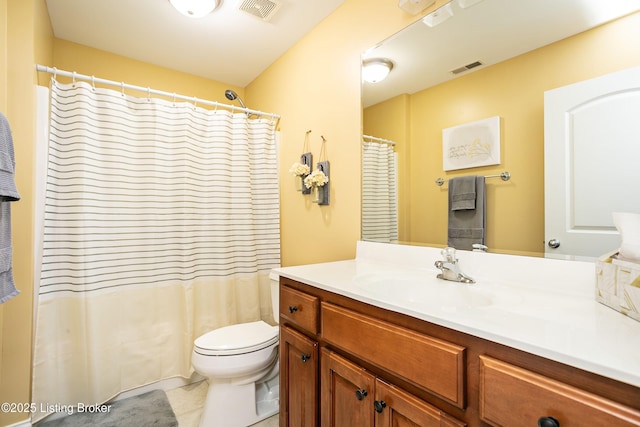 bathroom featuring vanity, curtained shower, tile patterned floors, and toilet