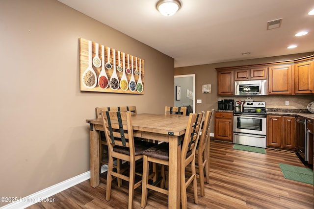 dining area with dark wood-type flooring