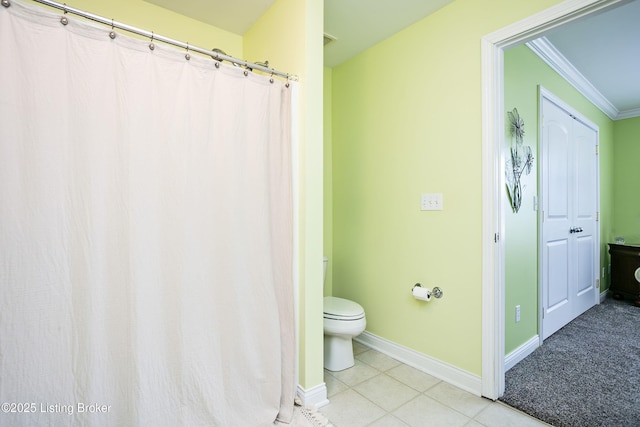 bathroom with crown molding, tile patterned floors, and toilet