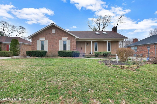 single story home with brick siding, a chimney, and a front lawn