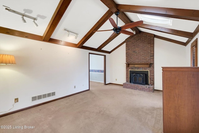 unfurnished living room with a ceiling fan, visible vents, baseboards, vaulted ceiling with beams, and light colored carpet