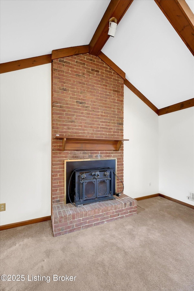 unfurnished living room featuring baseboards, lofted ceiling with beams, and carpet