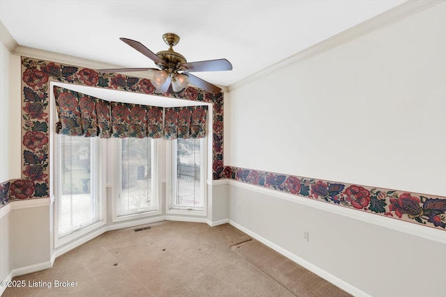 unfurnished dining area featuring baseboards, visible vents, ceiling fan, crown molding, and carpet flooring