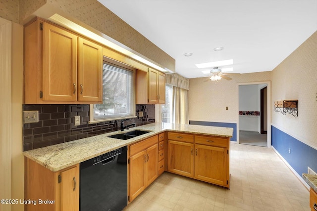 kitchen featuring wallpapered walls, light stone countertops, dishwasher, a peninsula, and a sink