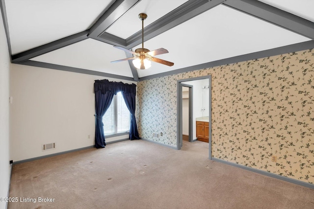 unfurnished room featuring visible vents, wallpapered walls, baseboards, carpet, and lofted ceiling with beams