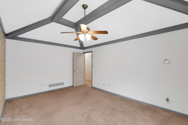 carpeted spare room featuring visible vents, baseboards, ceiling fan, and vaulted ceiling with beams