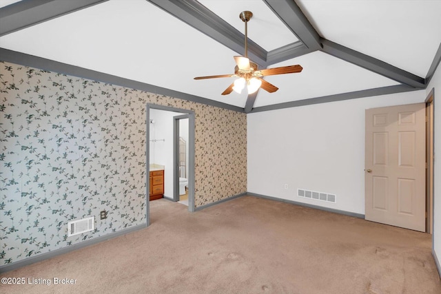 empty room with lofted ceiling with beams, visible vents, light colored carpet, and wallpapered walls