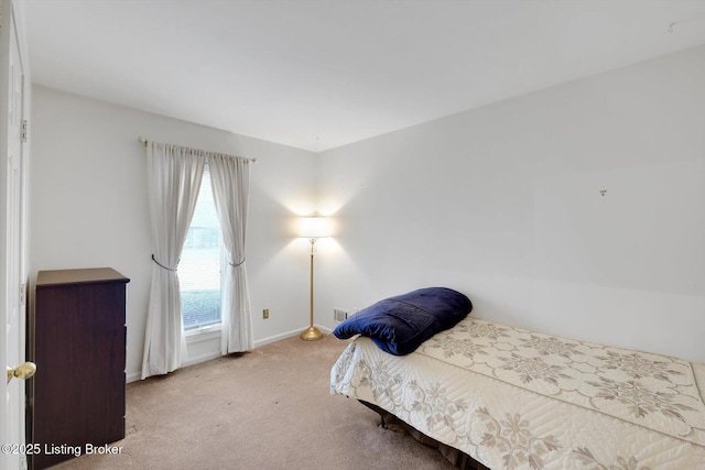 bedroom with baseboards and carpet