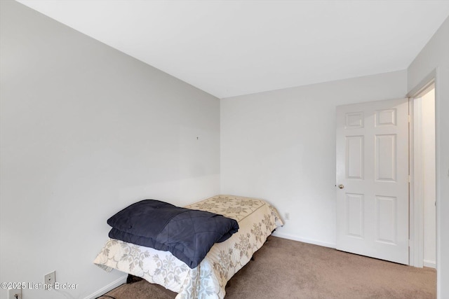 bedroom featuring baseboards and carpet